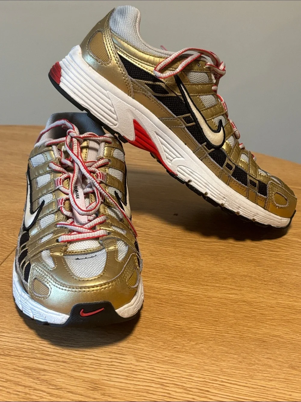 Nike BOWERMAN Metallic Gold, White & Black Athletic Sneakers with Red Details
